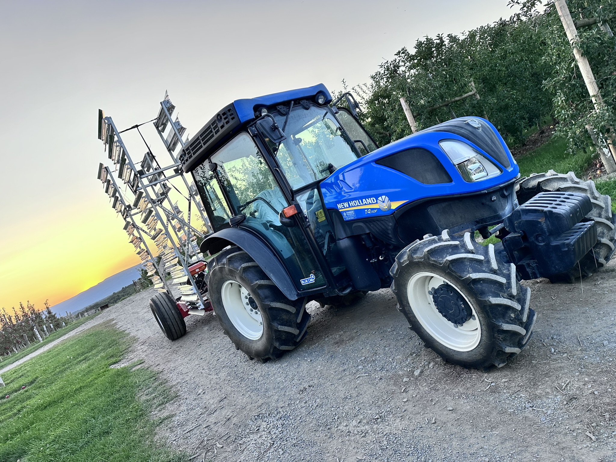 A blue tractor in the sunset.; A Century of Science: The Farmer-Researcher Partnership at Cornell Hudson Valley Lab and NYS Agricultural Experiment Station