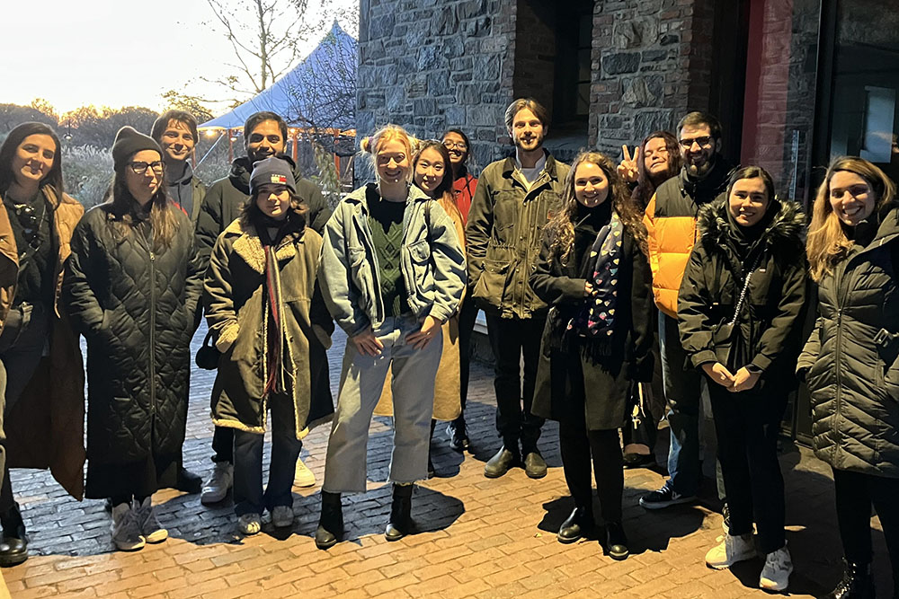 A class of warmly dressed Bard College students smiling and standing outside of stone building at Stone Barns Center.; Bard Professors Gabriel Perron and Swapan Jain Receive Research Support from Stone Barns Center for Food and Agriculture