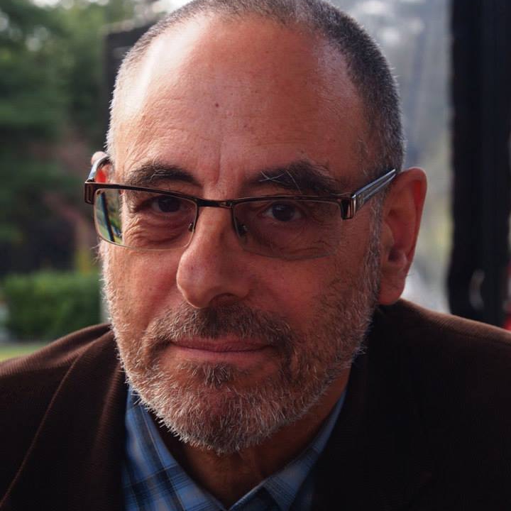 An author photo of a man in glasses looking at the camera.; Dissolving Words