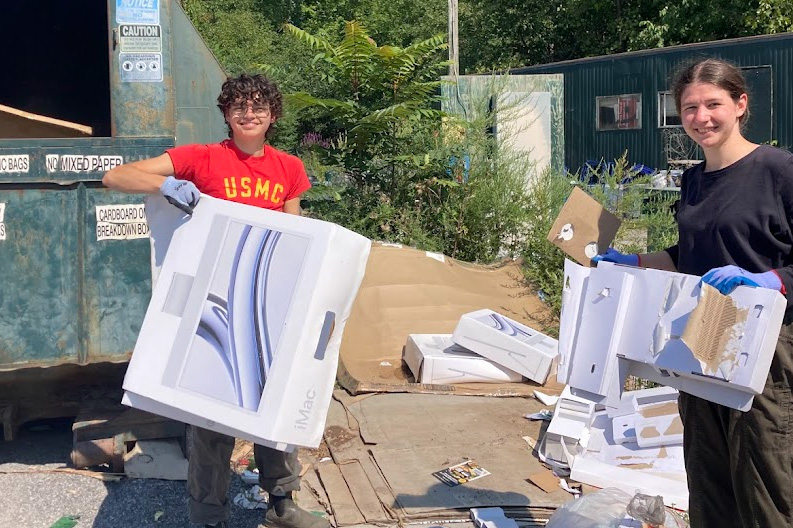 Students remove contaminants from the cardboard before placing in the recycling compactor.